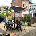 Conservatory opening into the back garden at The Limes